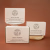 Three House 81 soaps at different heights on a brown background.