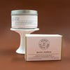 House 81 tin candle and goat's milk soap on a brown background.
